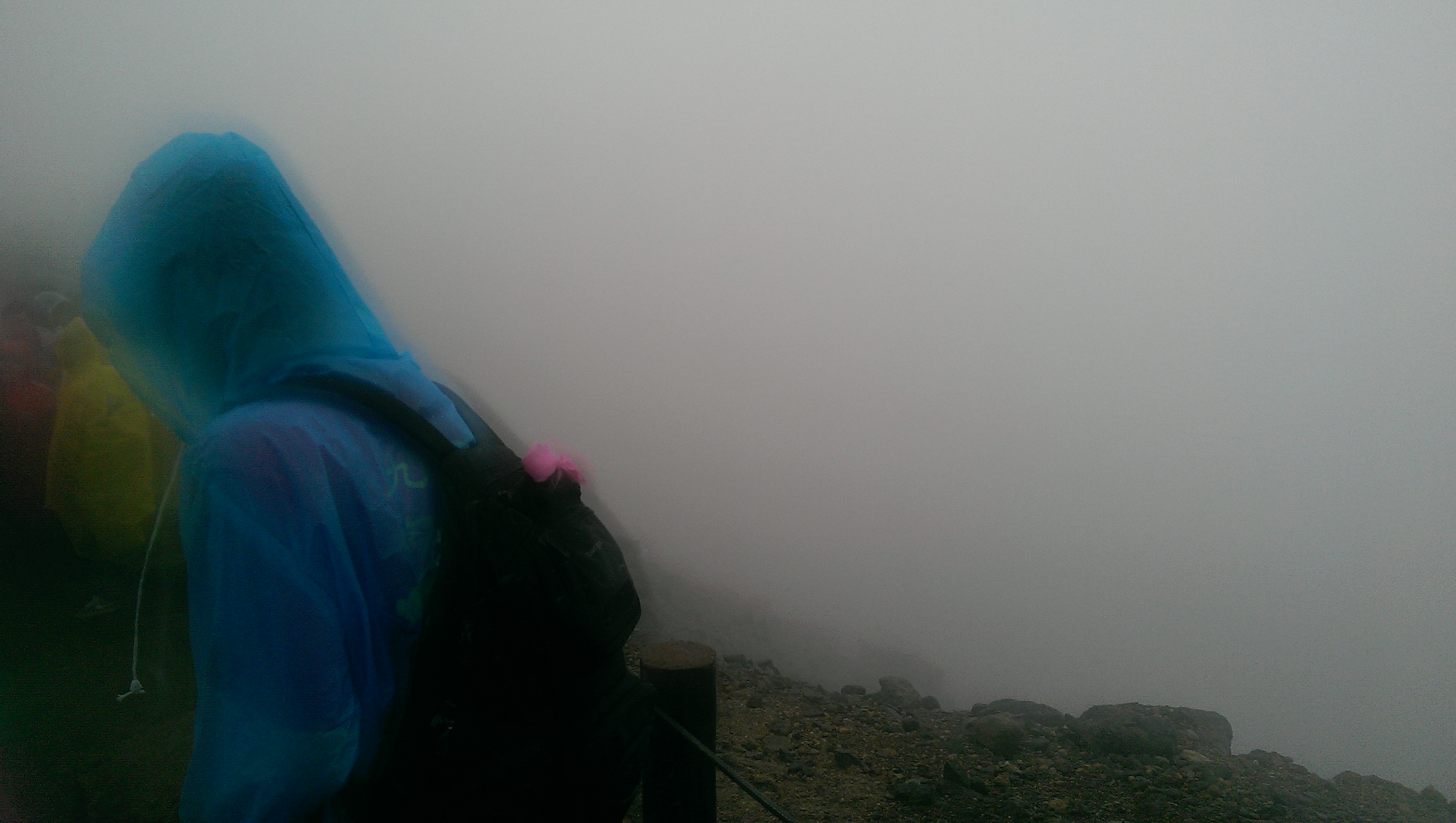 [The view of Heaven Lake: a guy in a blue raincoat and featureless white mist]